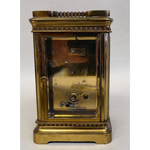 33 - A lacquered brass travel timepiece with bevelled glass panels; the movement faced by an enamelled Ro... 