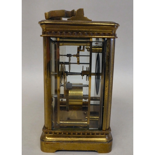 33 - A lacquered brass travel timepiece with bevelled glass panels; the movement faced by an enamelled Ro... 