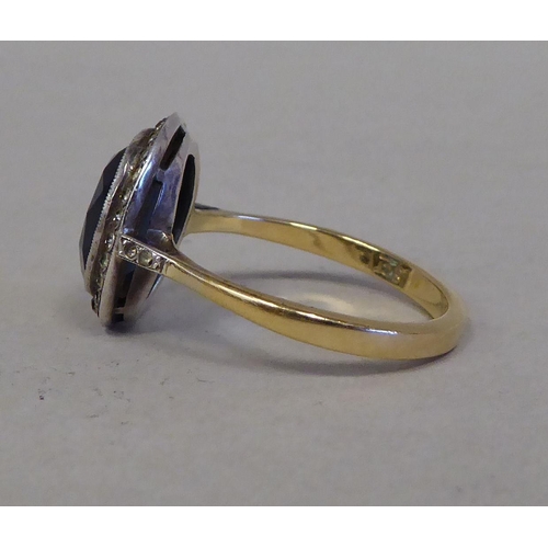 35 - An 18ct gold cluster ring, set with blue and white stones&nbsp; (approx. weight 4.9 grams)