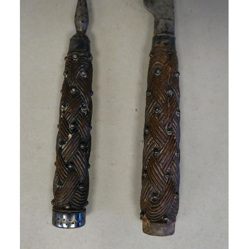 36 - A late 18thC Scottish steel knife and fork, each with a carved rope knot design handle