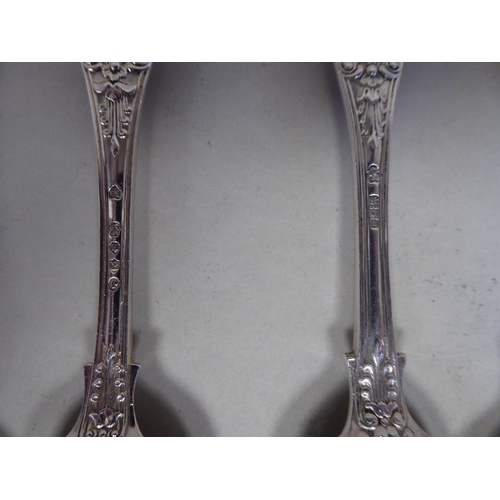 37 - A matched set of twelve silver Queens pattern dessert spoons  mixed Victorian and later marks  (appr... 