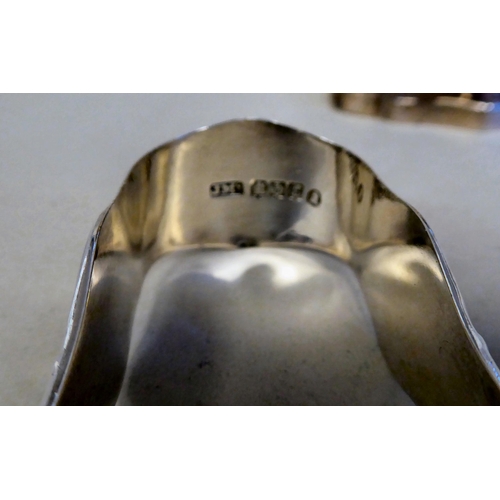 43 - A Georgian silver pedestal sugar basket of oval outline with a swing handle and a matching cream jug... 