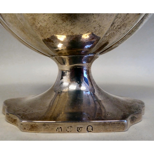 43 - A Georgian silver pedestal sugar basket of oval outline with a swing handle and a matching cream jug... 