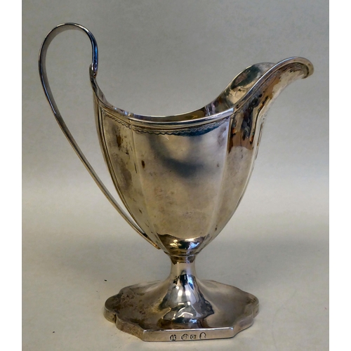 43 - A Georgian silver pedestal sugar basket of oval outline with a swing handle and a matching cream jug... 