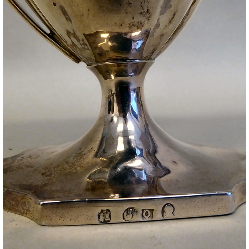 43 - A Georgian silver pedestal sugar basket of oval outline with a swing handle and a matching cream jug... 