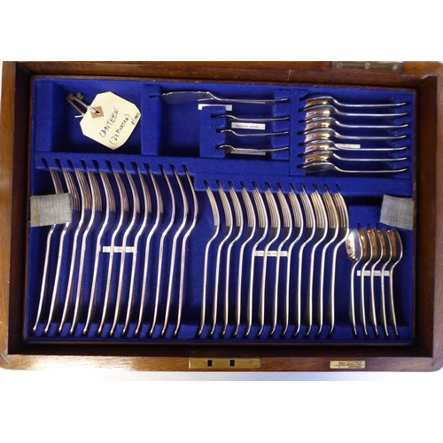 48 - A Walker & Hall stainless steel canteen, comprising twelve place settings, on simulated bone han... 