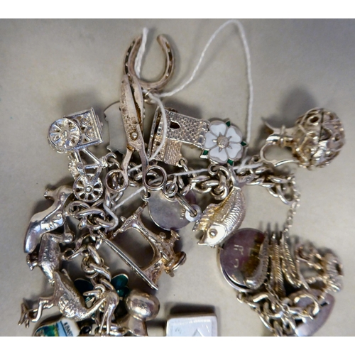 56 - Silver collectables: to include a charm bracelet&nbsp; (approx. gross weight 135 grams)