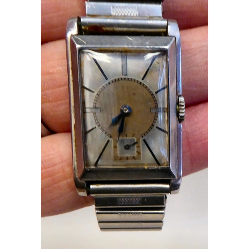57 - An Omega stainless steel cased manual, bracelet Tank watch, faced by a baton dial and subsidiary sec... 