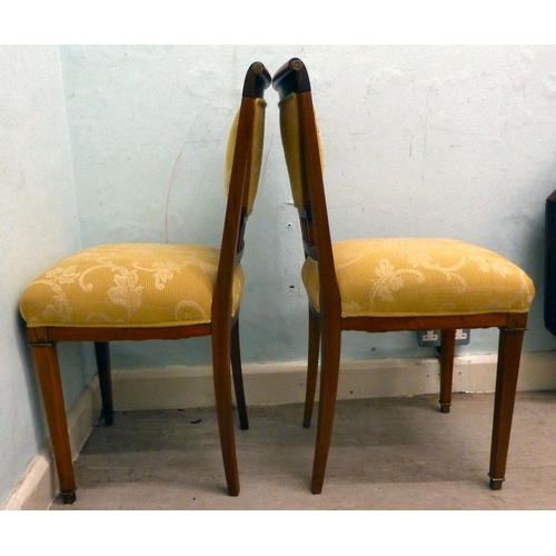 60 - A pair of late 19thC walnut framed, ormolu mounted bedroom chairs, each with an upholstered back and... 