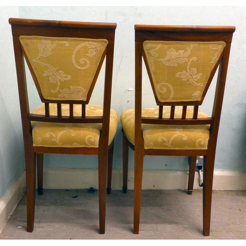 60 - A pair of late 19thC walnut framed, ormolu mounted bedroom chairs, each with an upholstered back and... 