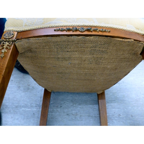 60 - A pair of late 19thC walnut framed, ormolu mounted bedroom chairs, each with an upholstered back and... 