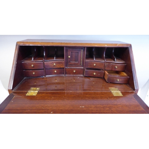 9 - A modern Korean teak Georgian style bureau, in the manner of a trader's sample with brass fittings  ... 