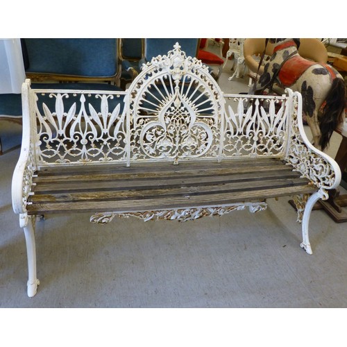 250 - A modern cast iron three person garden bench with a slatted wooden seat  62