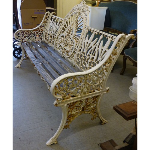 250 - A modern cast iron three person garden bench with a slatted wooden seat  62