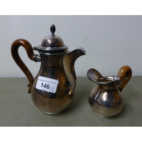 146 - A white metal coffee pot with a wooden handle; and cream jugs&nbsp; stamped 800&nbsp; (approx. combi... 