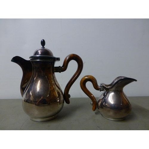 146 - A white metal coffee pot with a wooden handle; and cream jugs&nbsp; stamped 800&nbsp; (approx. combi... 