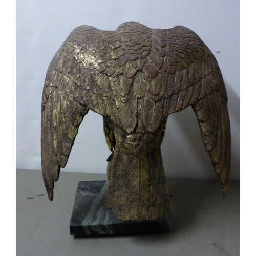 159 - A modern gilded composition bald eagle, on a ball finial and marble effect plinth  15