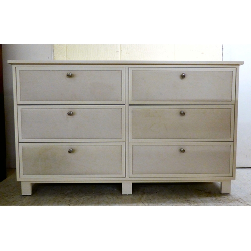 170 - A modern white painted dressing chest with six drawers, each covered with a fabric panel front, rais... 