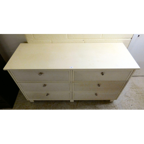 170 - A modern white painted dressing chest with six drawers, each covered with a fabric panel front, rais... 