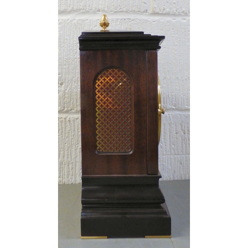 32 - A modern reproduction of a Georgian mahogany mantel timepiece by Knight & Gibbins of London; the... 