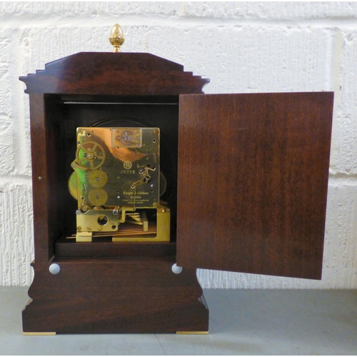 32 - A modern reproduction of a Georgian mahogany mantel timepiece by Knight & Gibbins of London; the... 