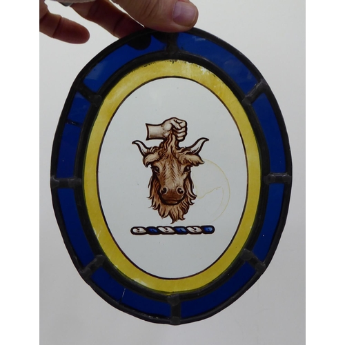 15 - An early/mid 20thC lead and coloured glass oval panel with a reverse painted cartouche  6.5