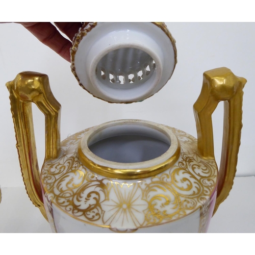 17 - A pair of Augustus Rex porcelain pedestal vases and covers, painted and hand finished, decorated wit... 