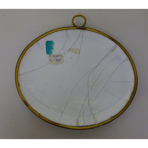 24 - An 18thC hand painted enamel oval plaque, depicting a period landscape with figures on a hillside, a... 