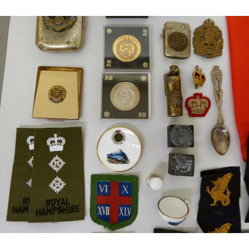 28 - Mainly Hampshire related militaria: to include a bayonet; printed sash; badges; buttons; and similar... 