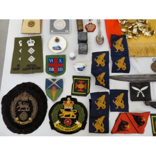 28 - Mainly Hampshire related militaria: to include a bayonet; printed sash; badges; buttons; and similar... 
