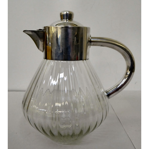 54 - A modern ribbed, clear glass lemonade jug with a silver plated collar, lid and handle with an intern... 