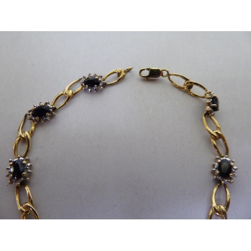 56 - A yellow metal (probably 9ct gold) bracelet, set with sapphires and diamonds  (approx. 5.79grms)