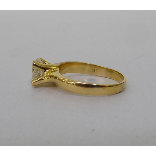 58 - A yellow metal single stone ring, set with a diamond  stamped 18k  (approx. 4.72grms)