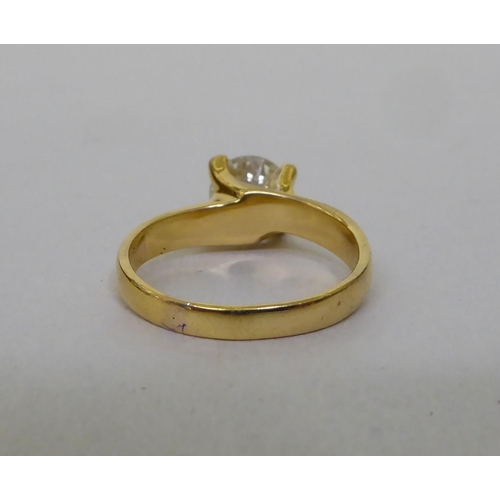 58 - A yellow metal single stone ring, set with a diamond  stamped 18k  (approx. 4.72grms)