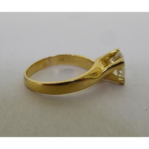 58 - A yellow metal single stone ring, set with a diamond  stamped 18k  (approx. 4.72grms)