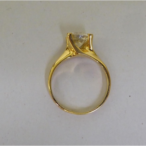 58 - A yellow metal single stone ring, set with a diamond  stamped 18k  (approx. 4.72grms)