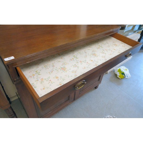 27 - An early/mid 19thC mahogany side cabinet with a frieze drawer, over a pair of panelled doors, raised... 