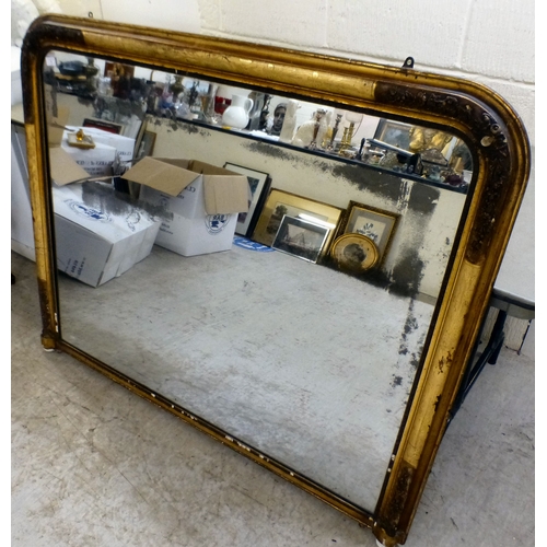1 - A 19thC overmantel mirror, the shaped plate set in a floral decorated, moulded gilt frame  42