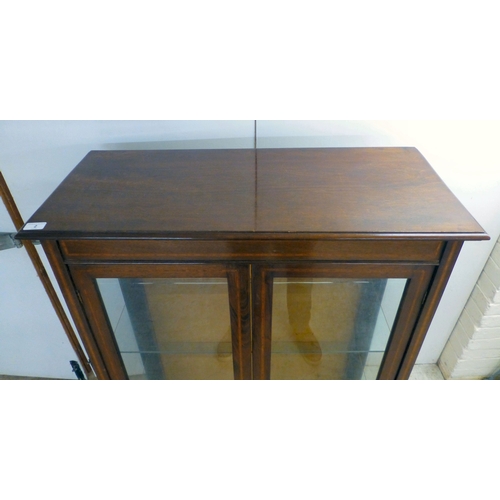 2 - An Edwardian string inlaid mahogany, two door bookcase, enclosing two glazed shelves, raised on stra... 