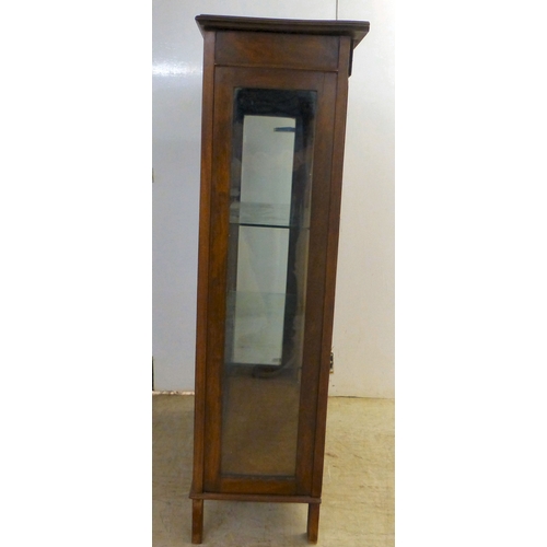 2 - An Edwardian string inlaid mahogany, two door bookcase, enclosing two glazed shelves, raised on stra... 