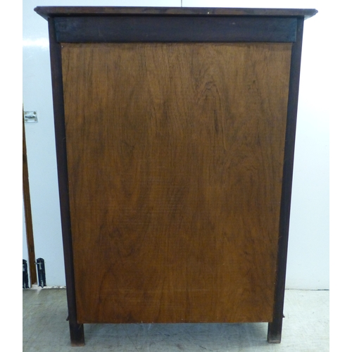 2 - An Edwardian string inlaid mahogany, two door bookcase, enclosing two glazed shelves, raised on stra... 