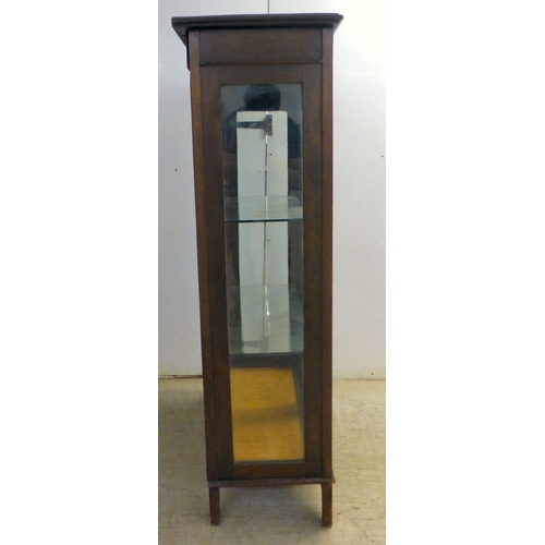 2 - An Edwardian string inlaid mahogany, two door bookcase, enclosing two glazed shelves, raised on stra... 