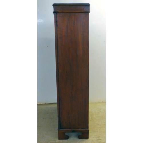 3 - An early 20thC mahogany two door cabinet, enclosing two shelves, over three in-line drawers, raised ... 