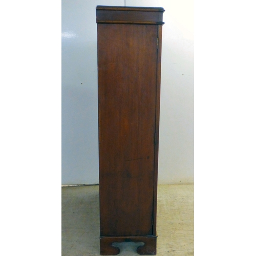 3 - An early 20thC mahogany two door cabinet, enclosing two shelves, over three in-line drawers, raised ... 