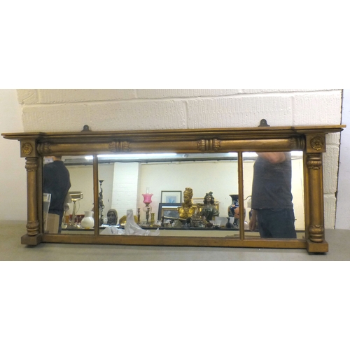 6 - A late 19thC gilt painted, inverted breakfront mirror, the three section plate set between pillar or... 