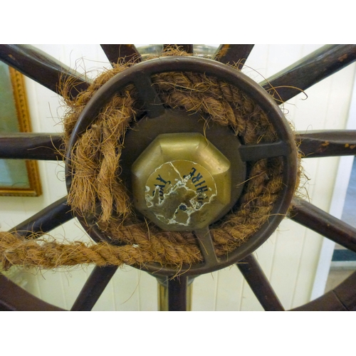 121 - A reproduction of a ships wheel, mounted on a brass column&nbsp; 60