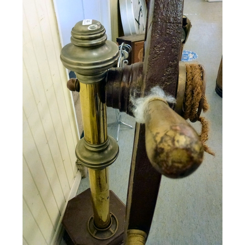 121 - A reproduction of a ships wheel, mounted on a brass column&nbsp; 60