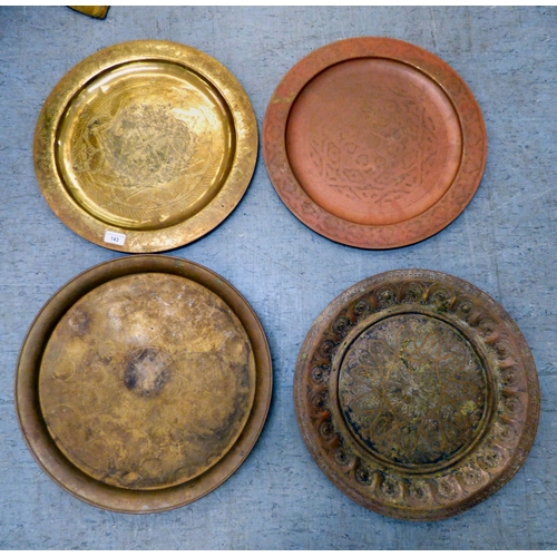 143 - Metalware: to include early/mid 20thC copper and brass, variously decorated tray tops&nbsp; largest ... 