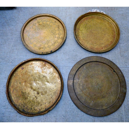 143 - Metalware: to include early/mid 20thC copper and brass, variously decorated tray tops&nbsp; largest ... 