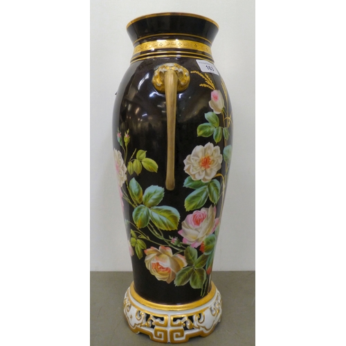 163 - A late Victorian porcelain vase with opposing mask handles, decorated with roses  17